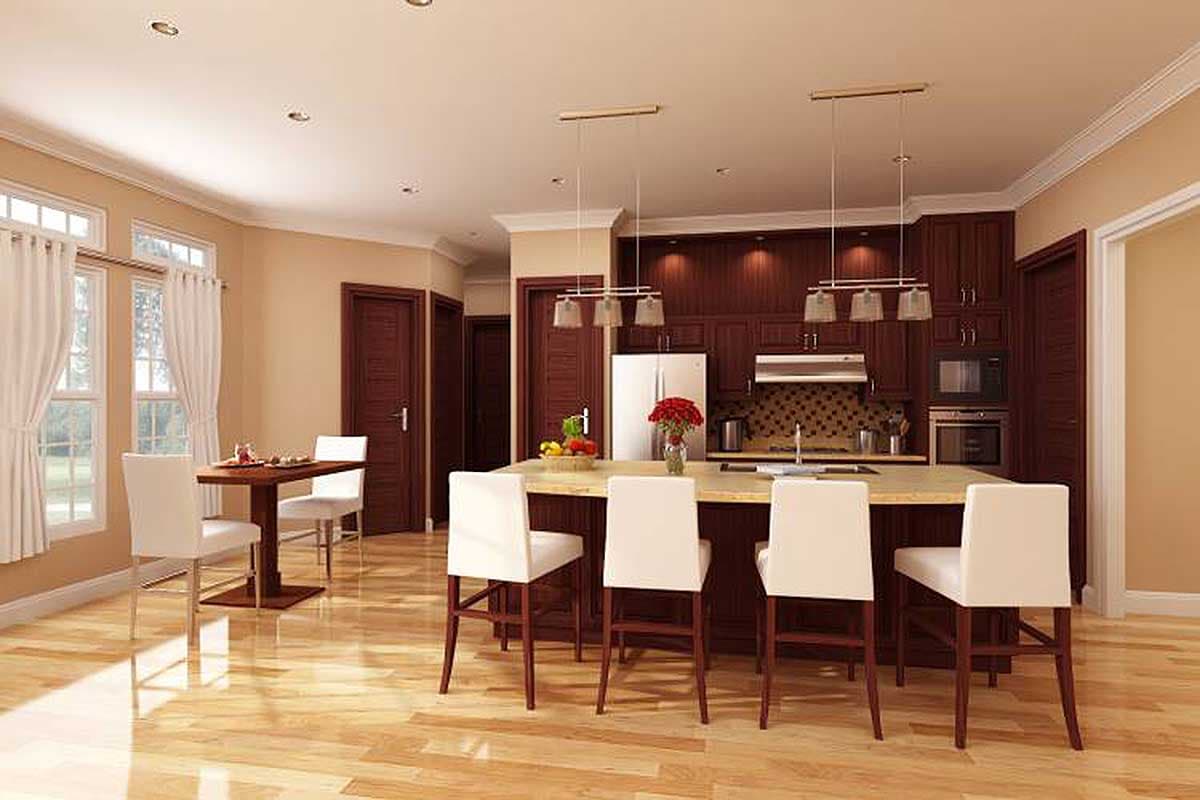 Modern kitchen with a large island, bar stools, dark wood cabinetry, stainless steel appliances, and a small dining area.