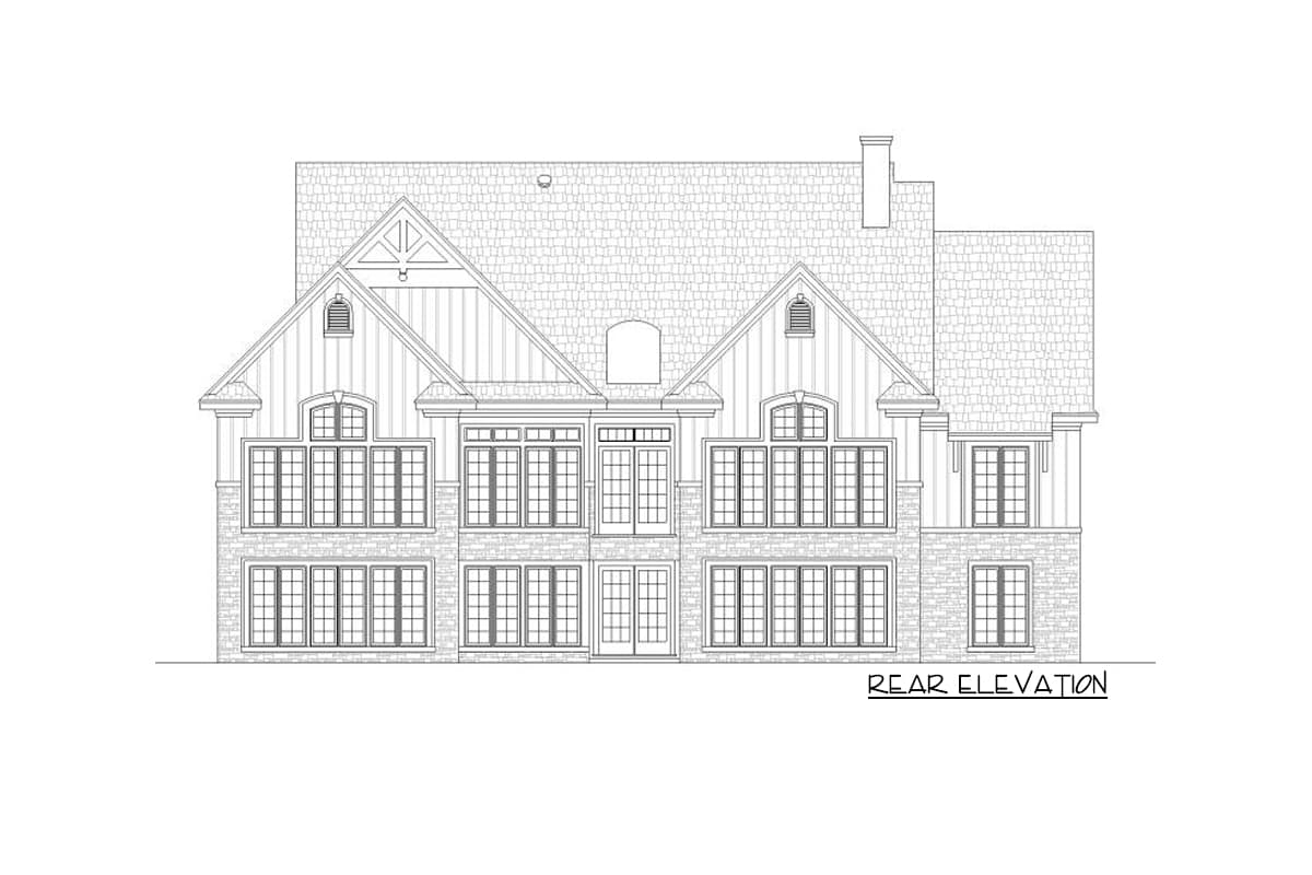 Rear elevation drawing of a multi-story house plan with gables, dormers, and stone and board siding.