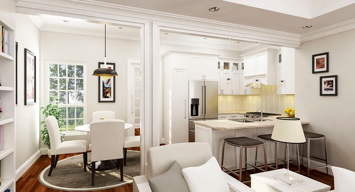Open concept dining area with round table and kitchen with island, stainless steel appliances, and pendant lights.