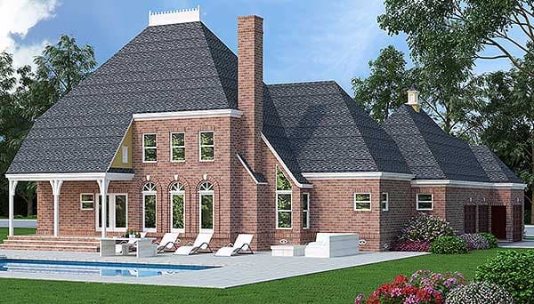 House plan exterior: Two-story brick home with a prominent mansard roof, multiple gables, arched windows, and a covered porch.