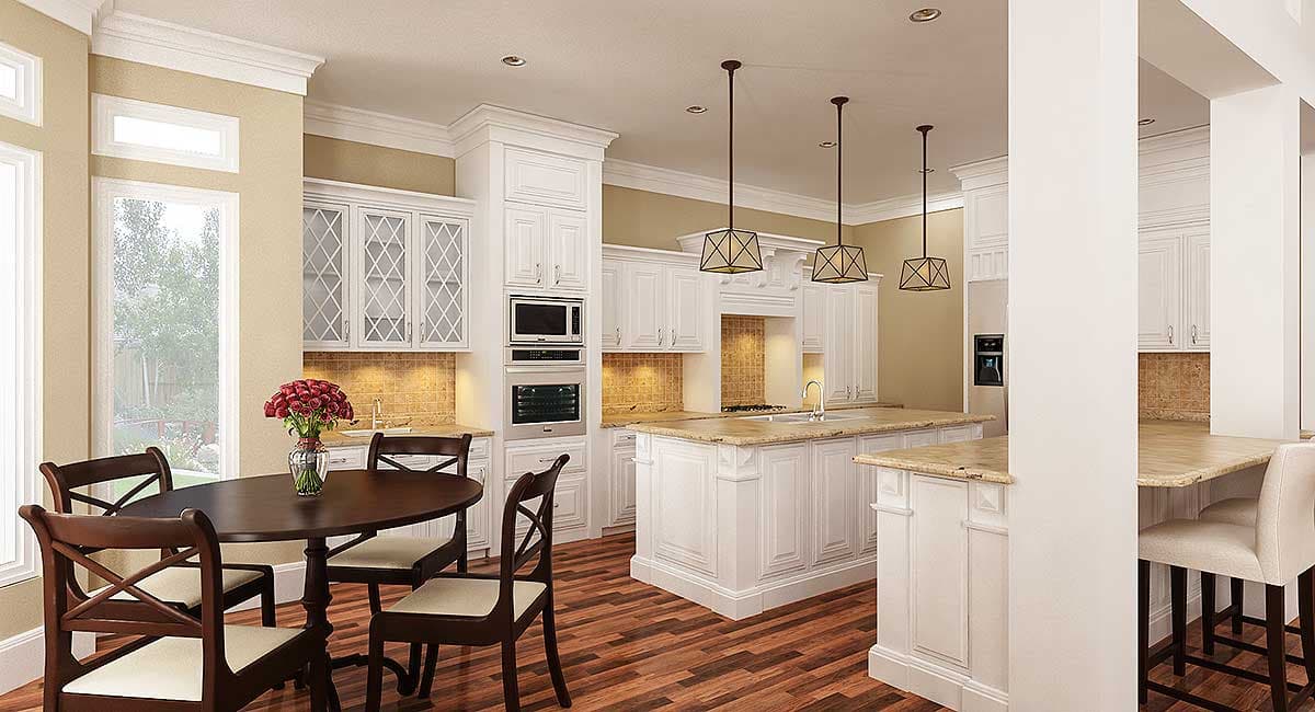 Kitchen with white cabinetry, large island with granite countertop, stainless steel appliances, and a dining area with a round table.