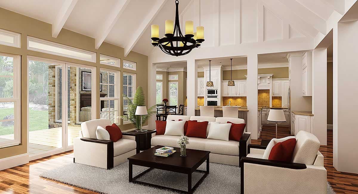 Living room with vaulted ceiling, open layout, large windows, and view of kitchen with island and white cabinetry.