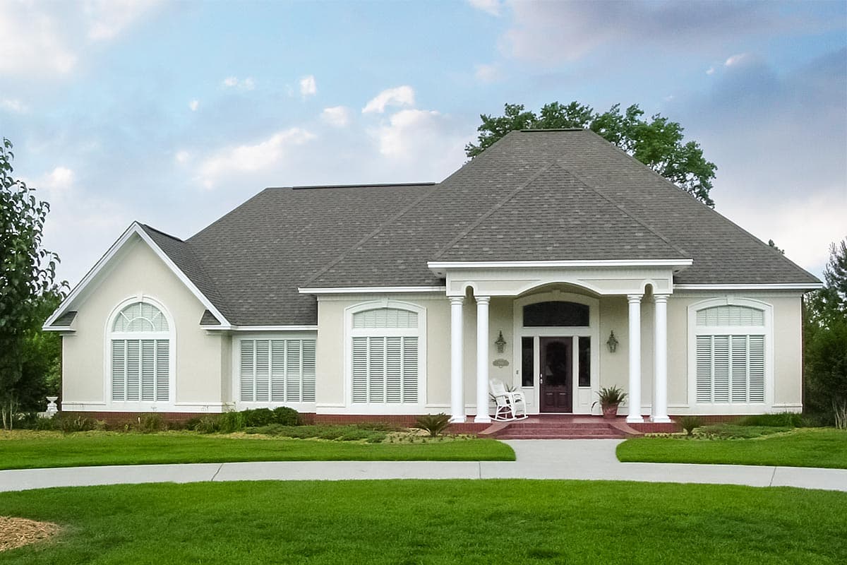 House plan exterior of a one-story stucco home with a prominent portico supported by columns and arched windows.