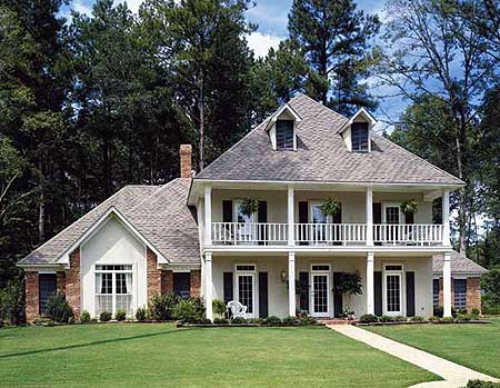 Two-story house plan exterior with a double-width front porch, dormers, and brick accents.