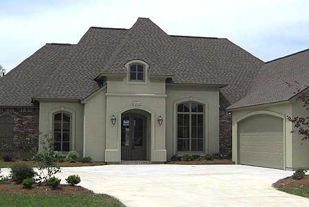 House plan exterior: One-story home with arched entry, stone accents, dormer, and attached garage.