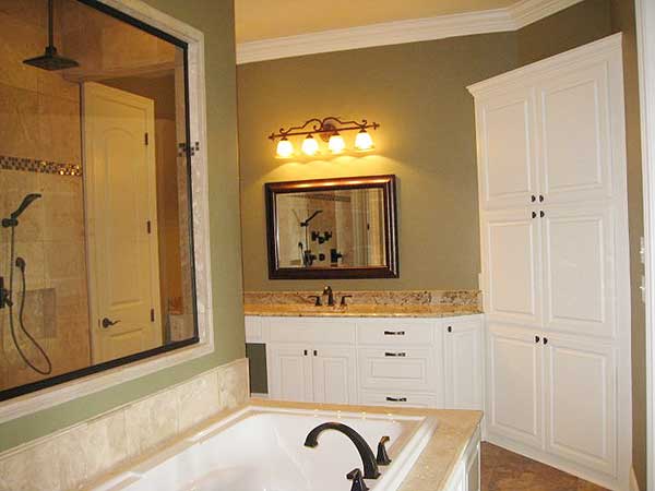 Bathroom with a walk-in shower, soaking tub, double vanity, and tall linen cabinet.