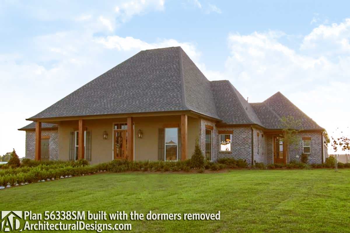 House plan exterior with a broad covered front porch supported by wood columns, brick and stucco facade, and multiple gables.