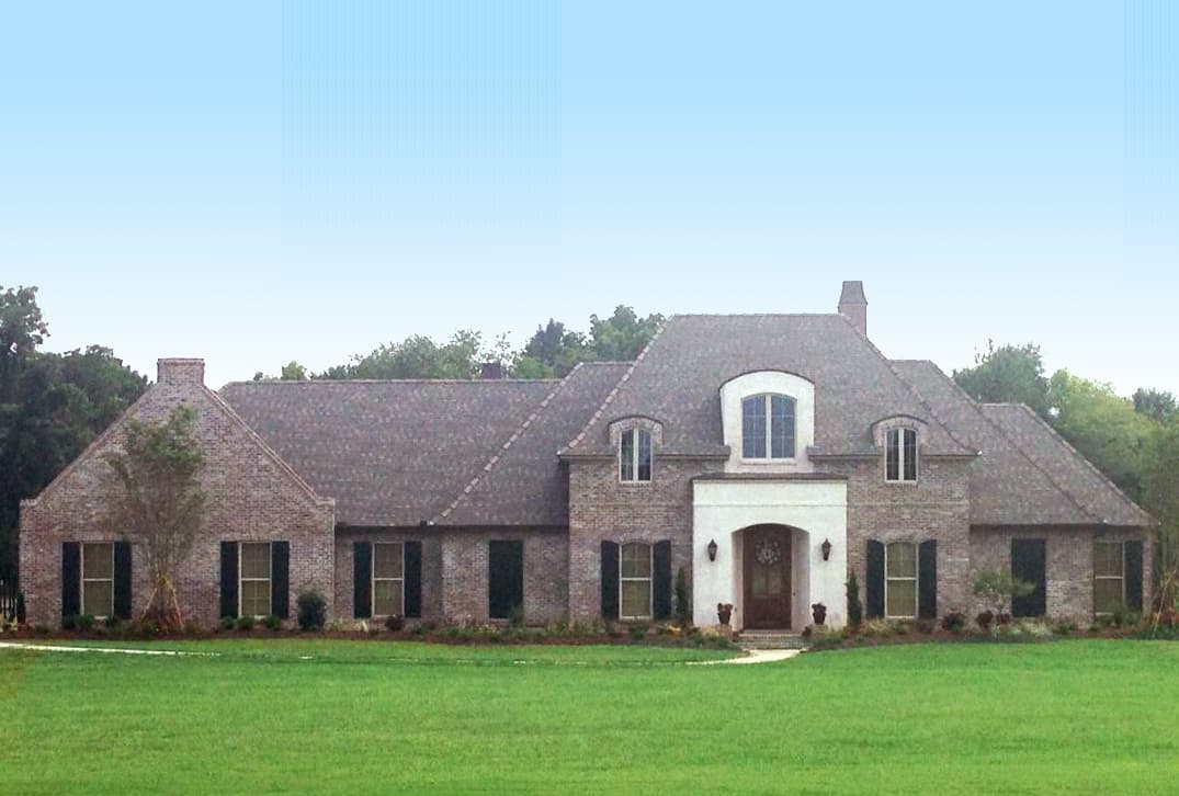 House plan exterior with brick facade, arched entryway, dormer windows, and multi-level rooflines.