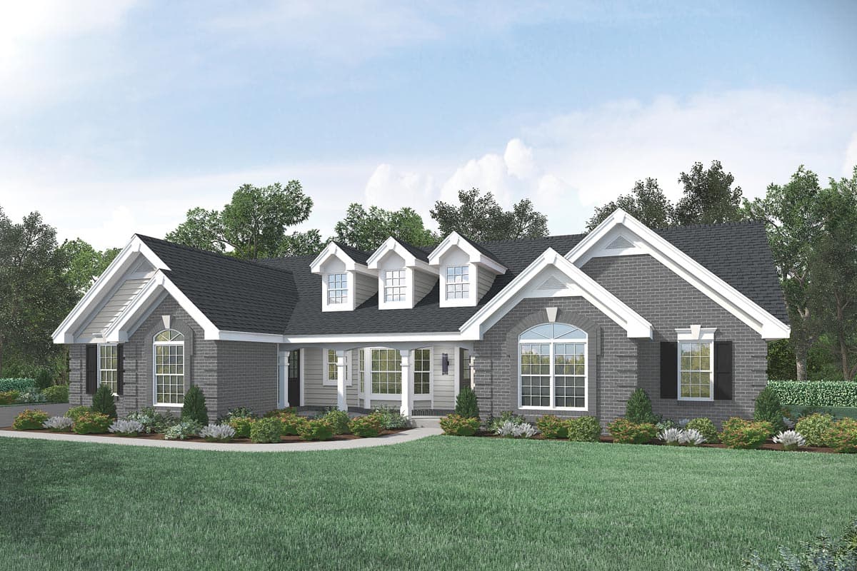 House plan exterior with dormers, brick facade, and front porch. Gable roof and multiple arched windows. Single-story house plan.