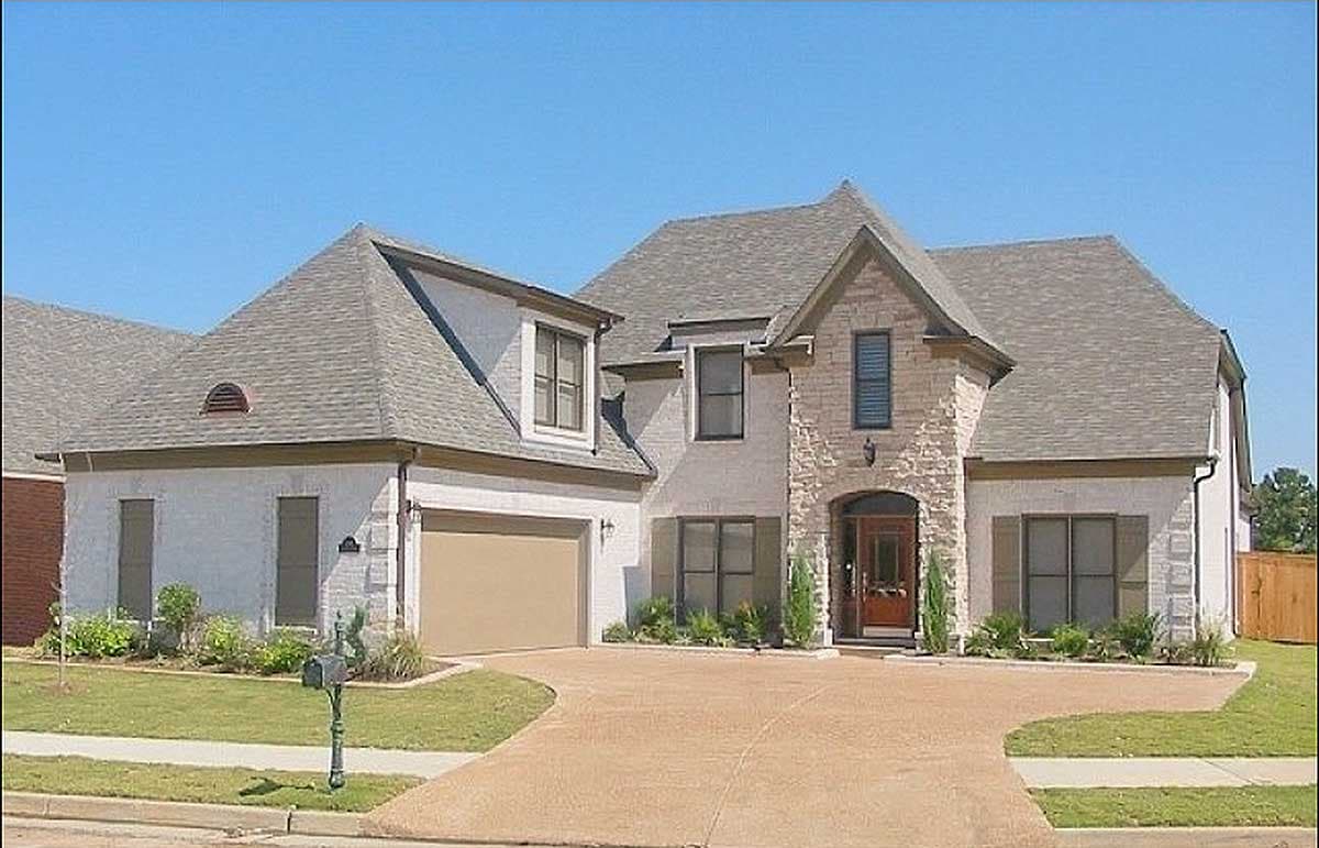 House plan exterior featuring a multi-gabled roof, stone-accented front facade, and attached two-car garage.
