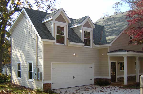 House plan exterior with a two-story side elevation, siding, a front-facing garage, and two dormer gables.