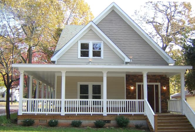 House plan exterior: Two-story home with full-width covered porch, stone accents, and dormer windows.