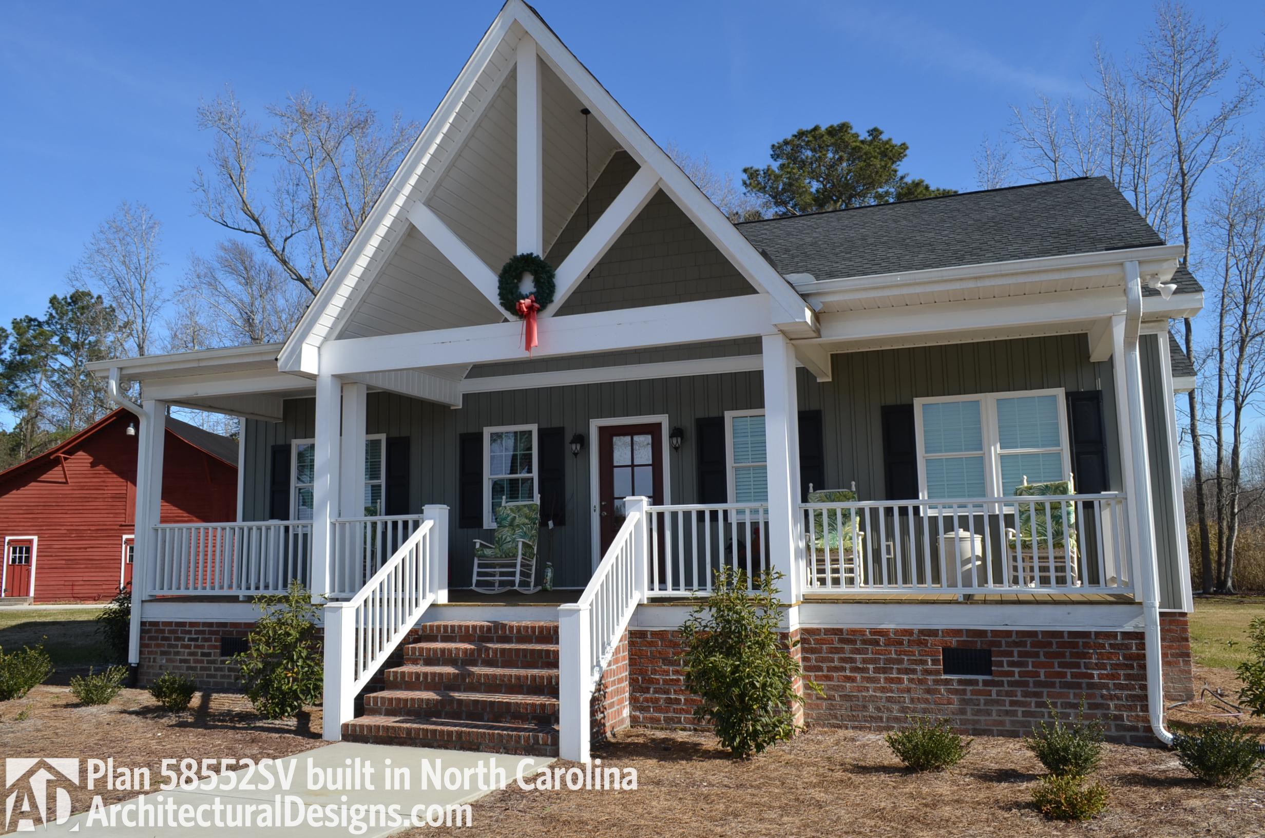 House plan exterior: Ranch style with wraparound porch, exposed rafter gable, and brick foundation.