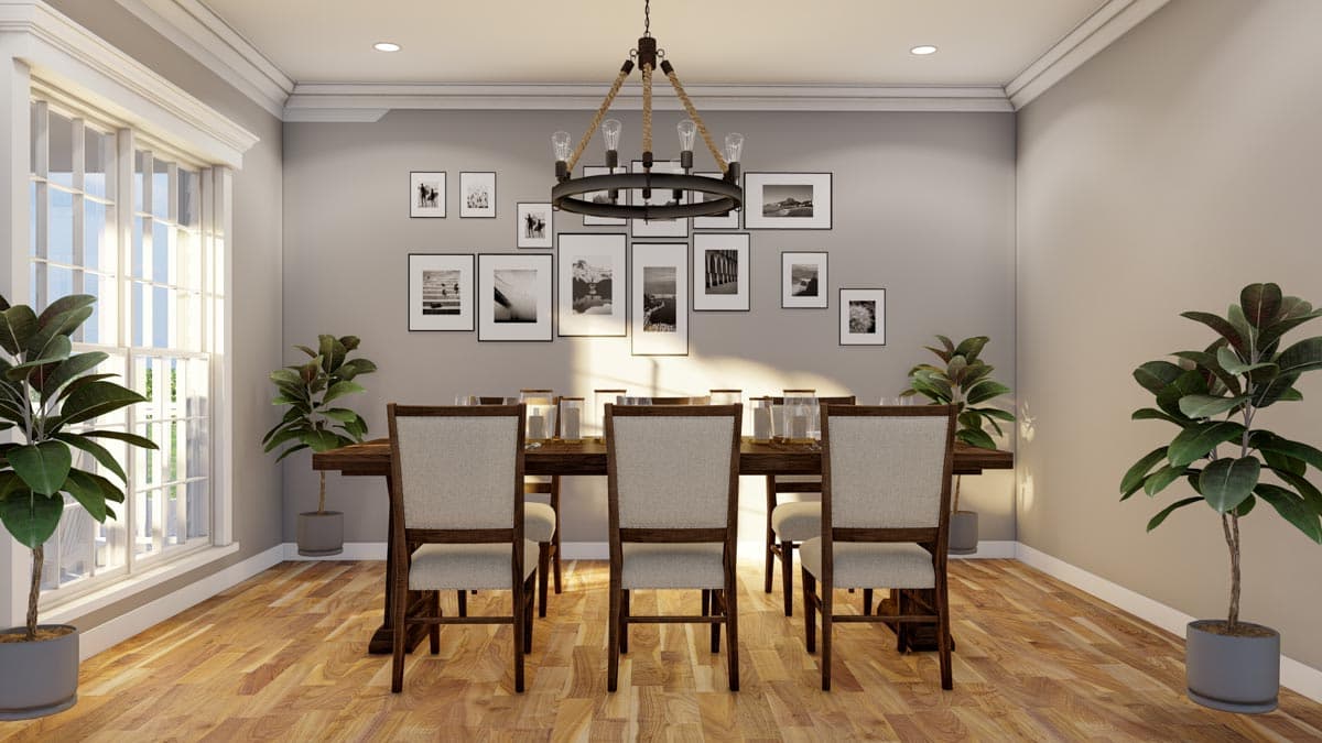Dining room with a long wooden table, upholstered chairs, large multi-pane window, and a gallery wall of black and white photographs.