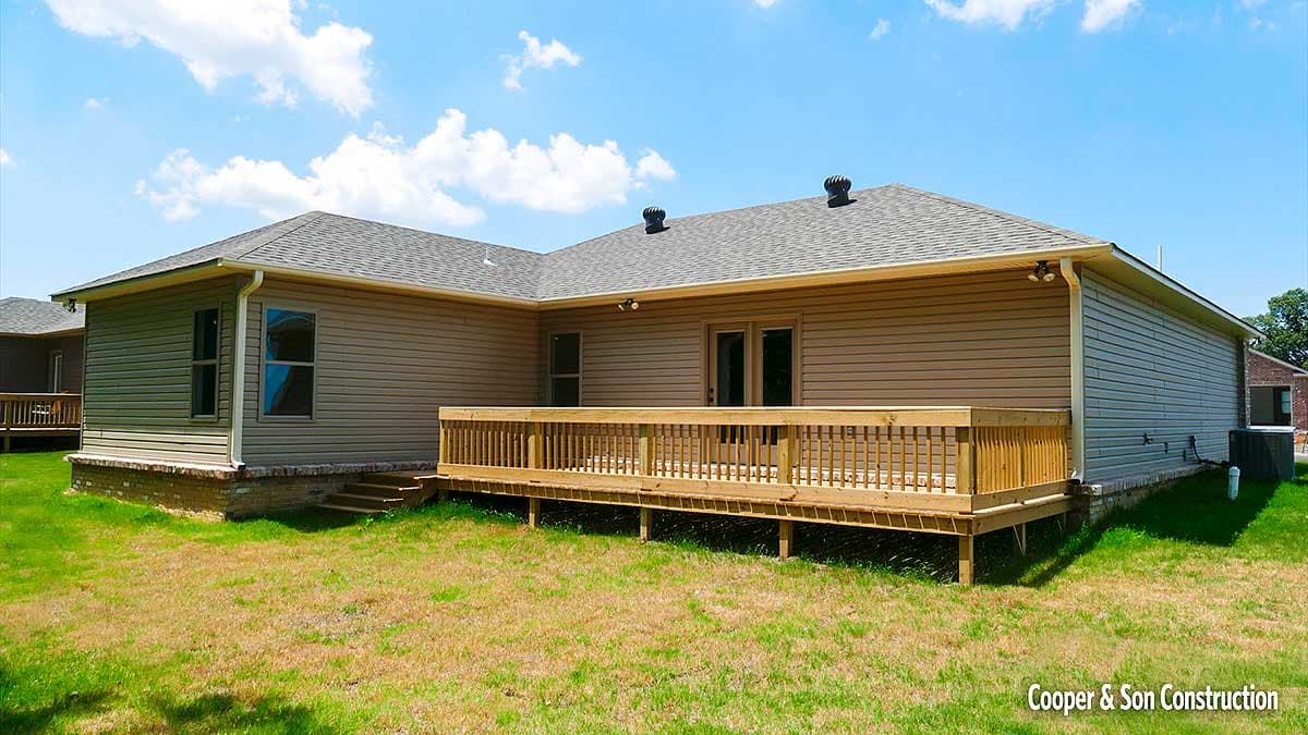 House plan exterior: Ranch style, single story, with vinyl siding, L-shaped deck, and dual roof vents.