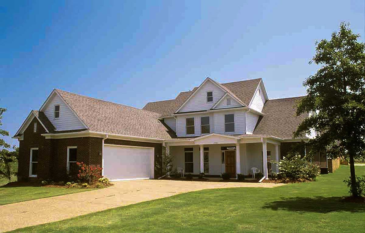 House plan exterior: two-story home with attached garage, prominent gables, dormer window, and covered front porch.