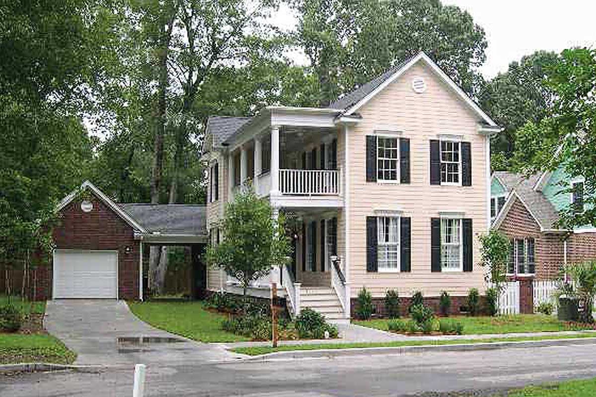 Two-story house plan exterior with a covered double-decker porch, attached garage, and gabled dormers.