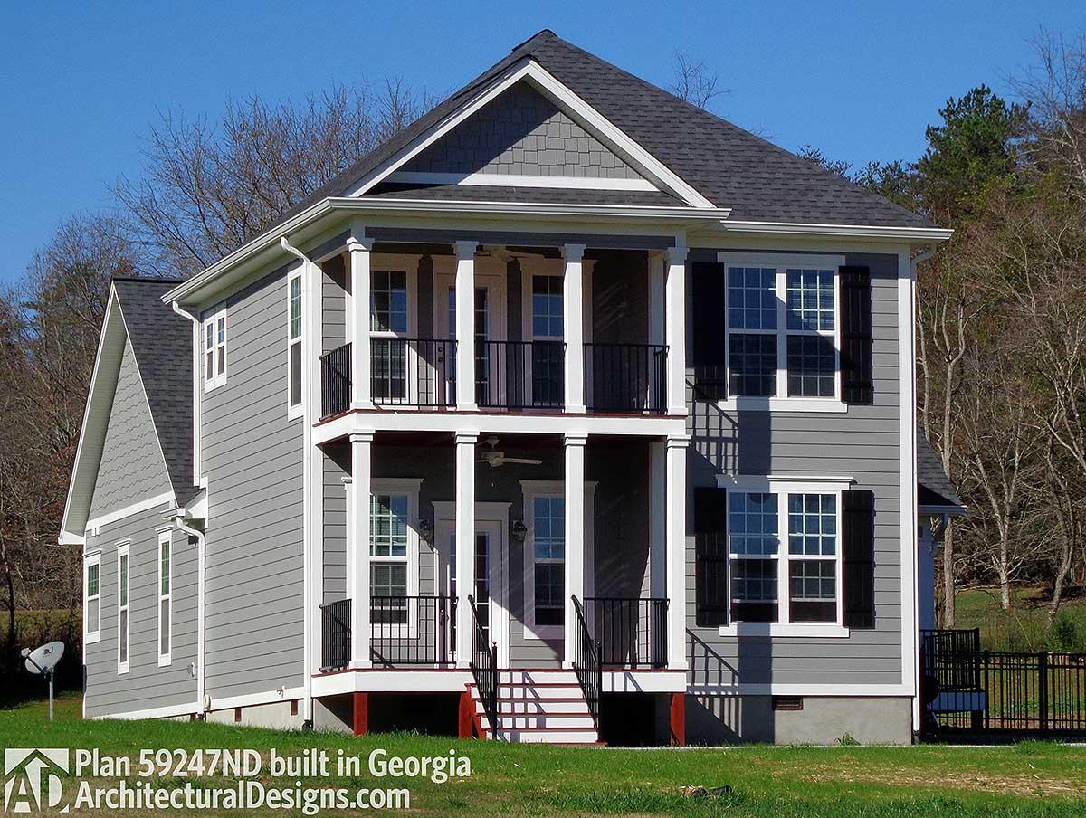House plan exterior, two stories, with double-decker front porch, multiple gables, and horizontal siding.