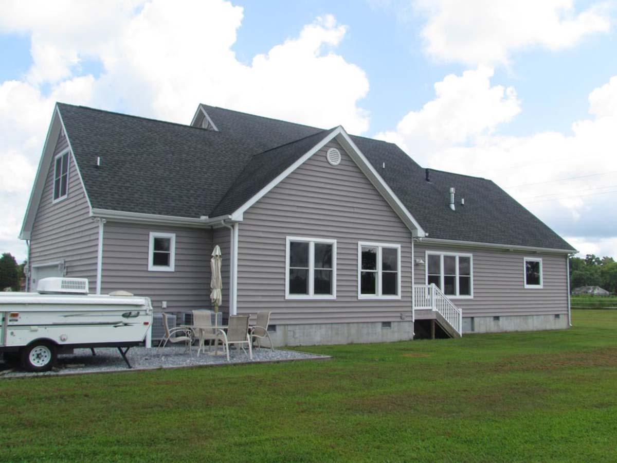 House plan exterior, one-story ranch with gabled dormer, prominent gables, and side-facing garage.