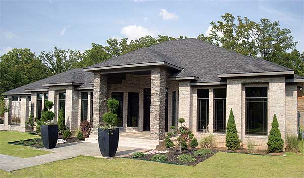 House plan exterior: Modern ranch with brick facade, stone accents, covered entry, and multi-level rooflines.