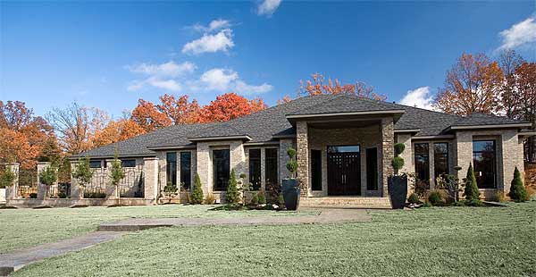 Ranch house plan exterior with a prominent covered entry, stone facade, and large windows.