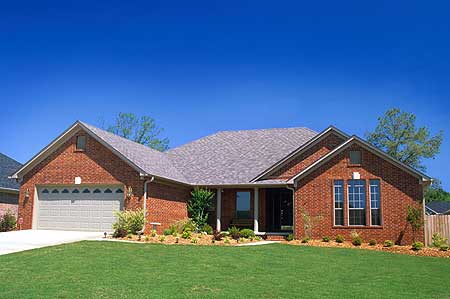 House plan exterior with brick facade, one-story layout, attached garage, and prominent gables under a gray roof.