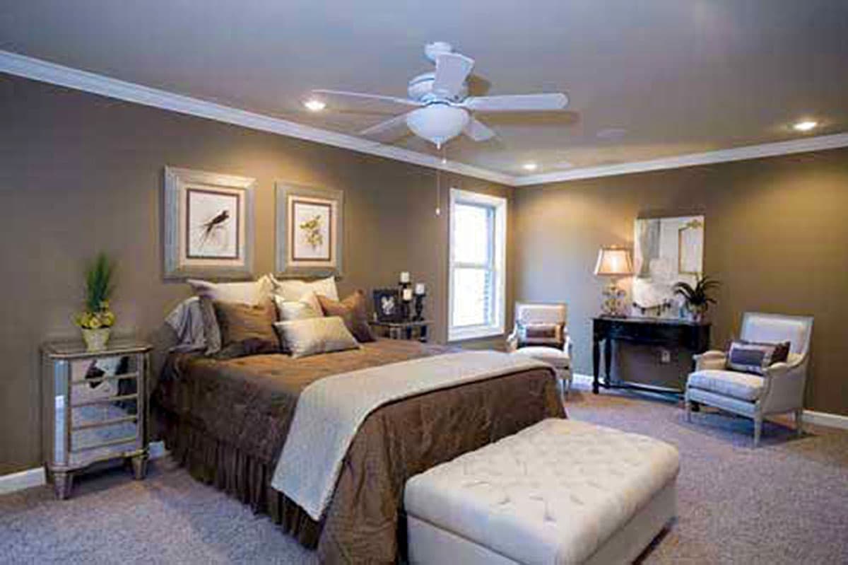Bedroom with king size bed, ceiling fan, recessed lighting, two framed wall art, and window.