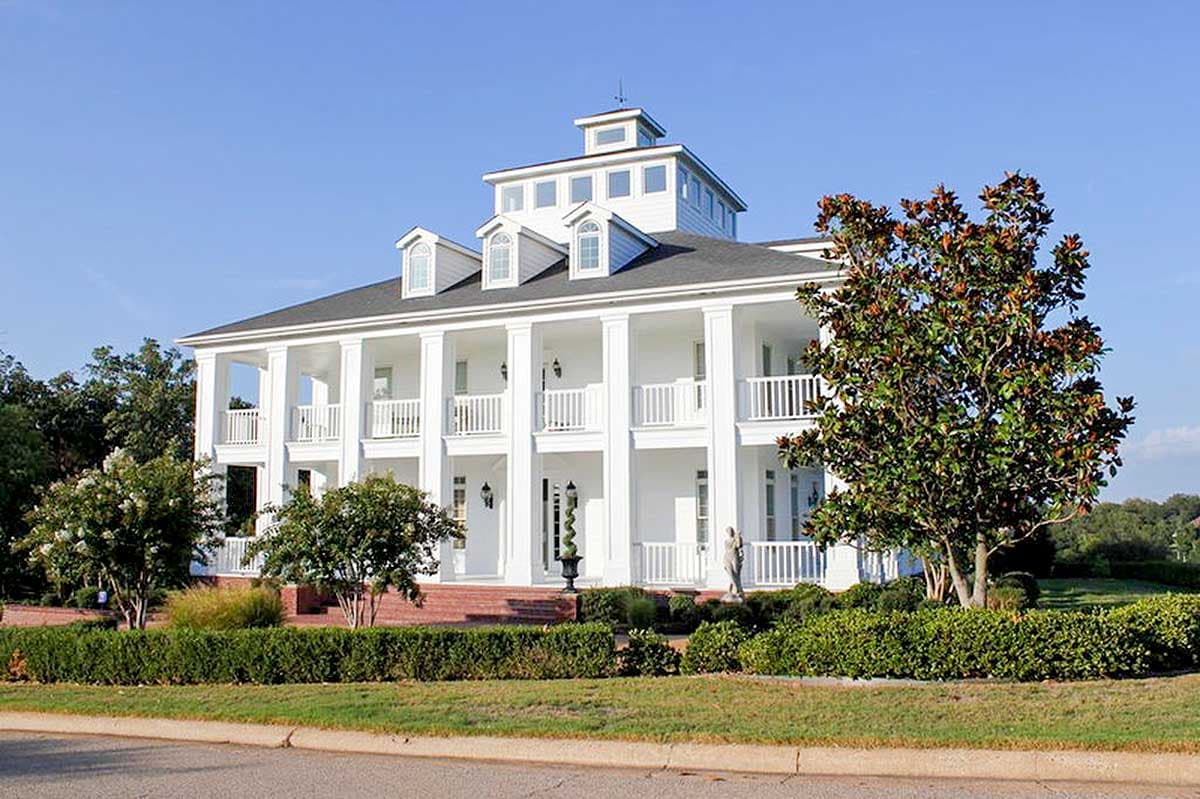Southern Colonial house plan exterior with a wraparound second-story porch, dormers, and a cupola.