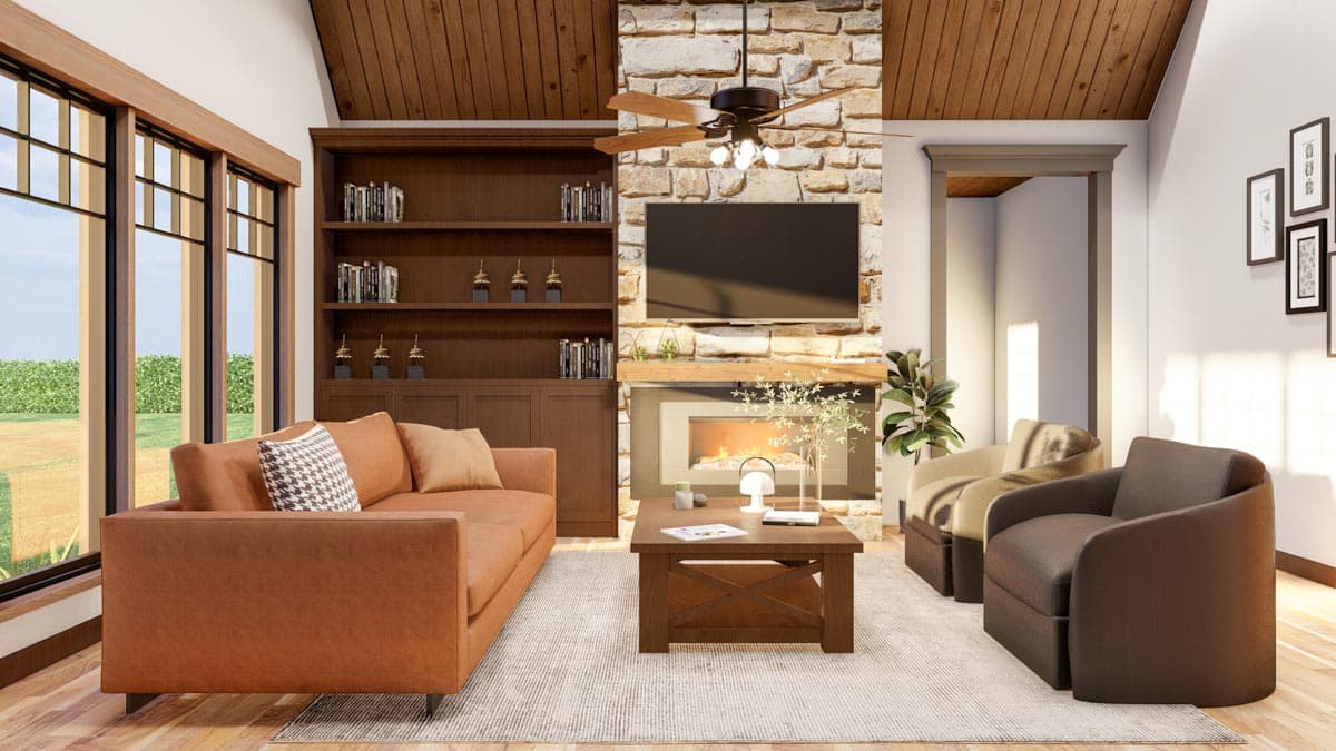 Great room with stone fireplace, built-in bookshelves, vaulted wood ceiling, and large windows.
