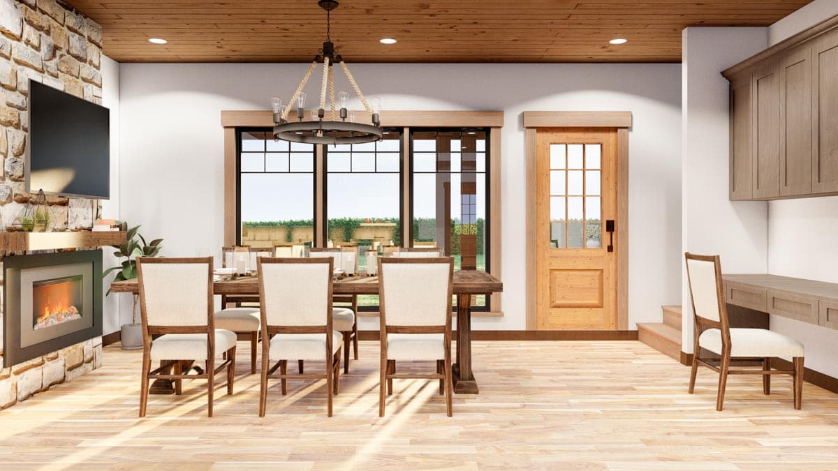 Interior rendering of dining room with stone fireplace, wood plank ceiling, large windows, and a wood-paneled door leading to stairs.