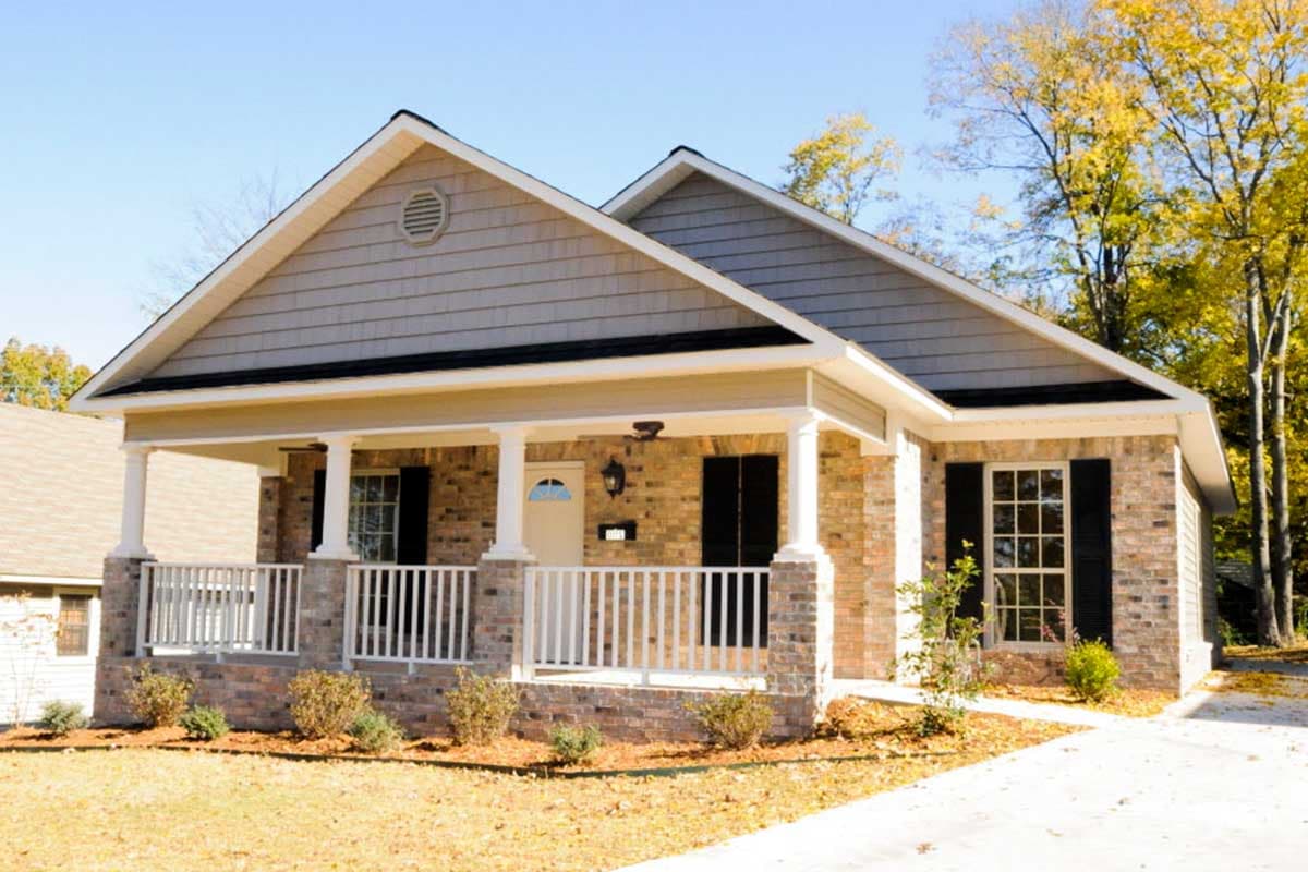 House plan exterior: Ranch style, single-story home with a covered front porch, brick accents, and gable rooflines.