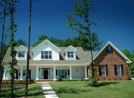 House plan exterior: two-story white house with brick section, full-width porch, dormers, and gables.