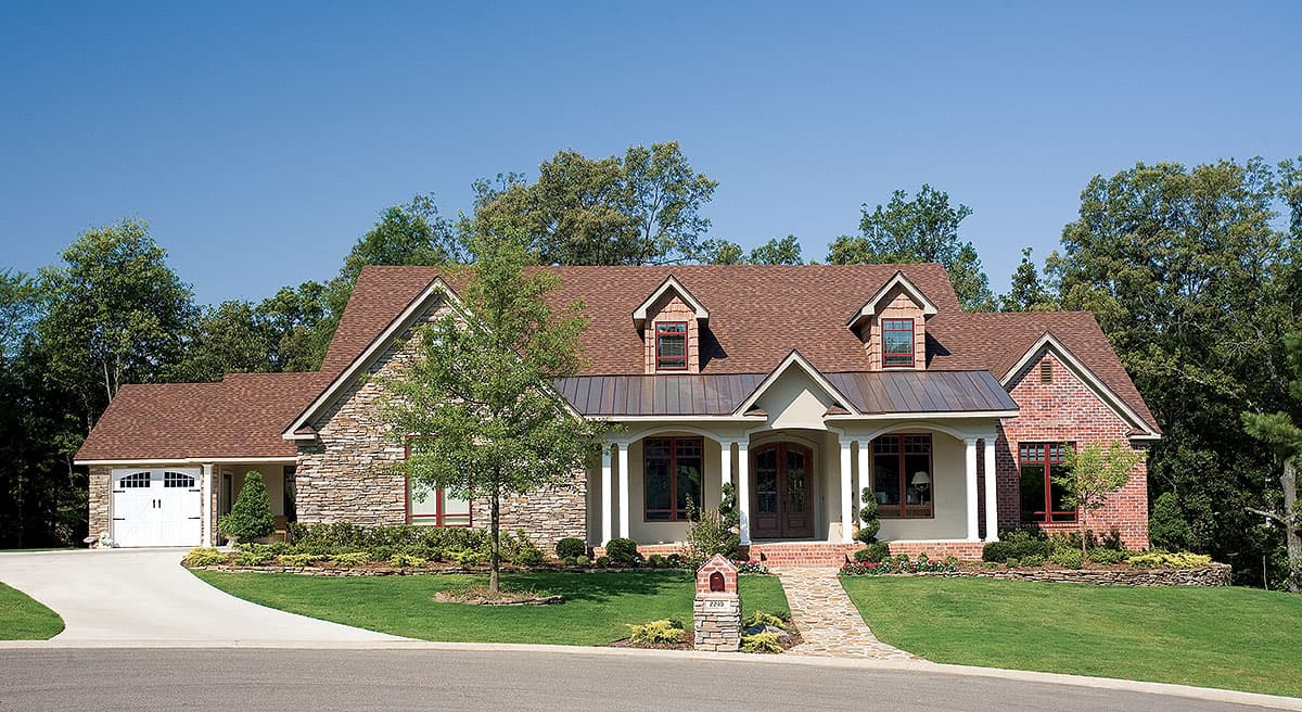 House plan exterior: Two-story home with stone and brick facade, central porch with columns, and a side-facing garage.