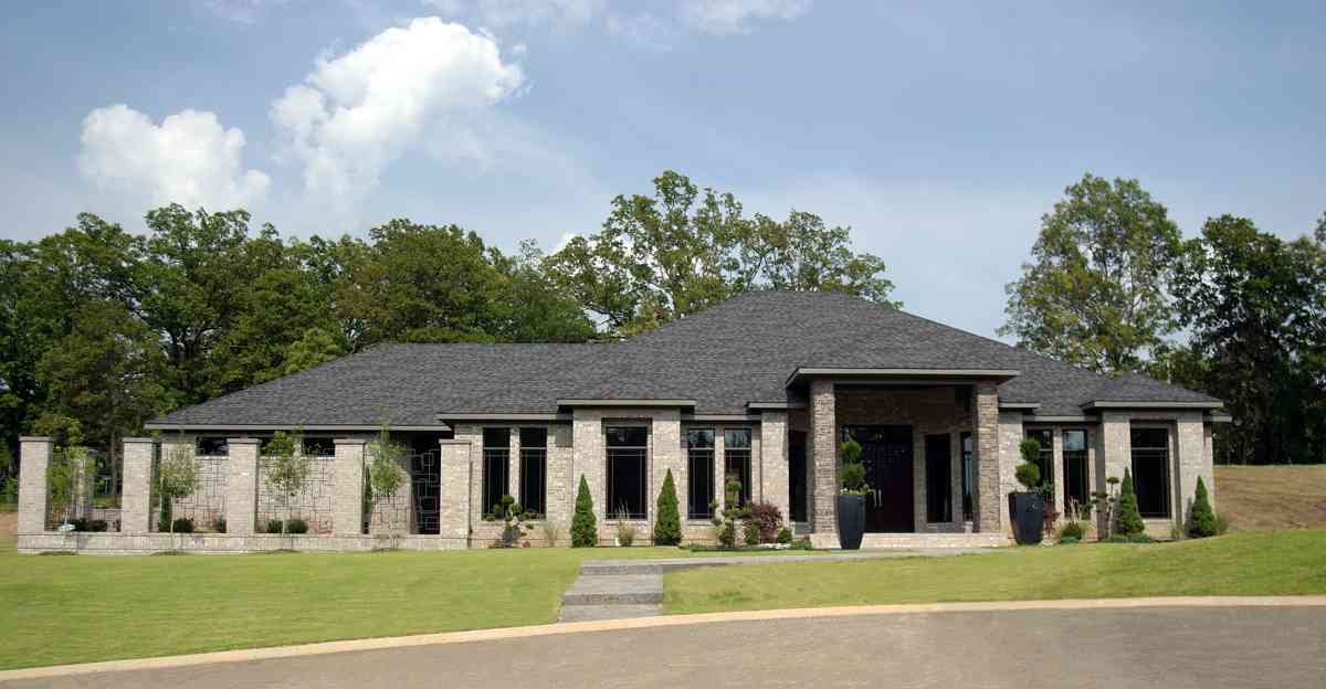 Modern ranch house plan exterior with a deep entry portico, brick facade, and multiple gables.