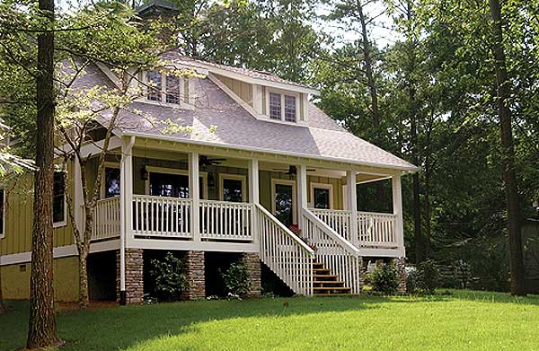 Craftsman style house plan exterior with a wraparound porch, dormers, and stone foundation.