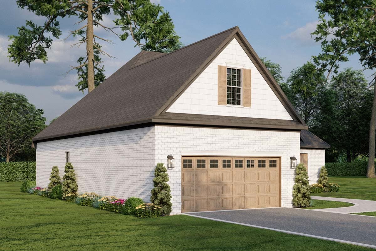 Two-story garage exterior with white brick, gambrel roof, large wooden carriage garage door, and upper gable dormer window.