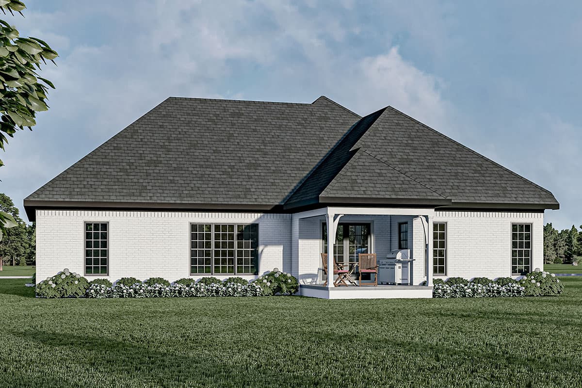House plan exterior of a one-story home with white brick, a covered porch with seating, and multiple large windows.