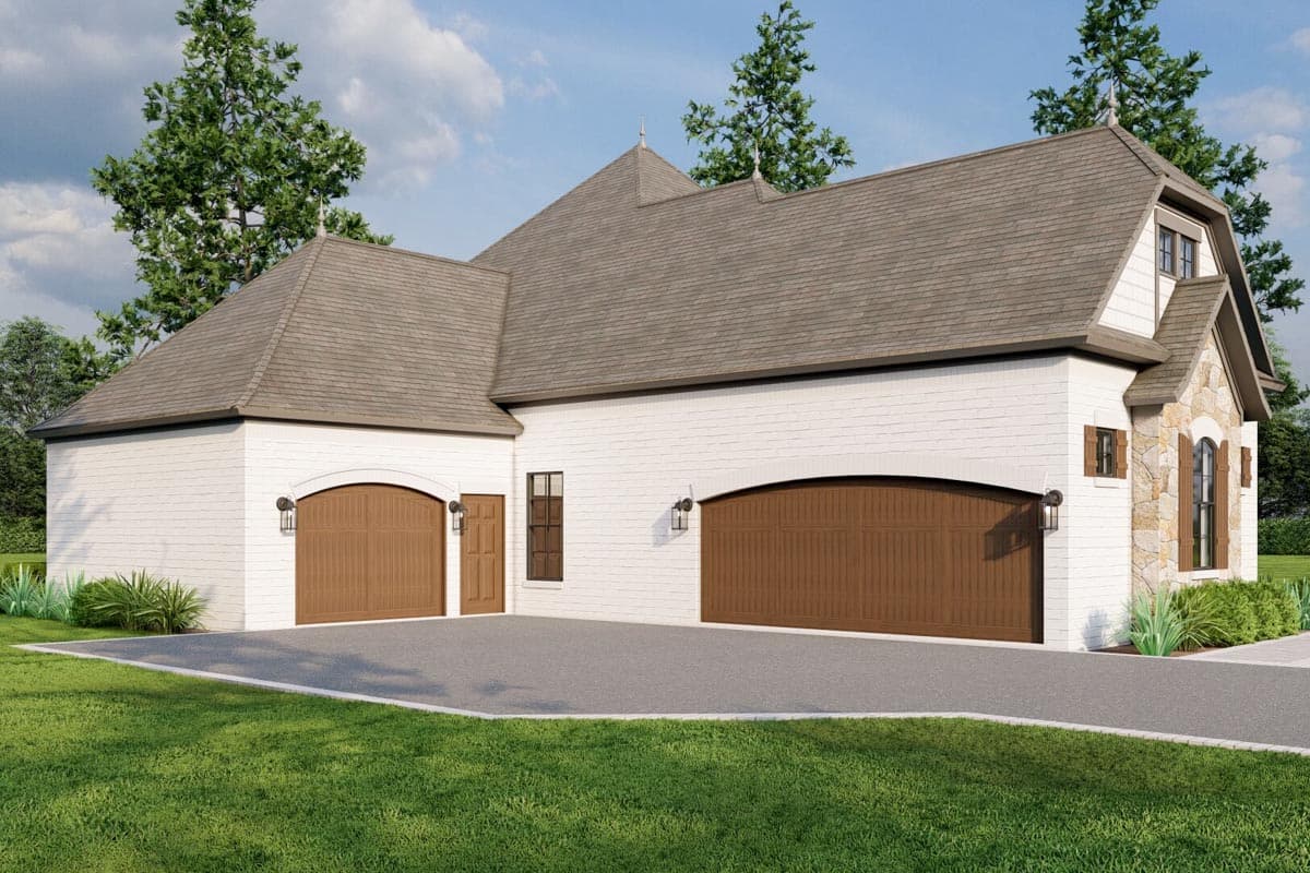 House plan exterior with white brick, a gambrel roof, two arched garage doors, and stone accents.