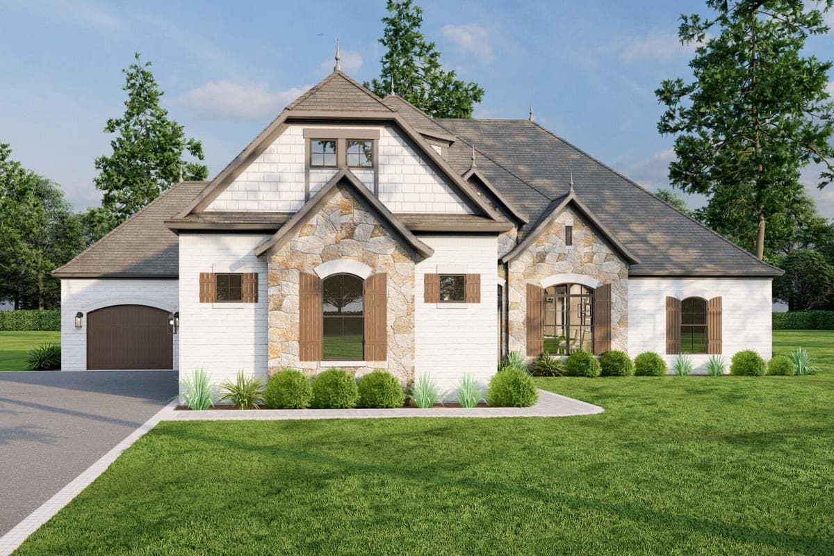 House plan exterior: Traditional style with stone accents, arched windows, dormers, and side-entry garage.