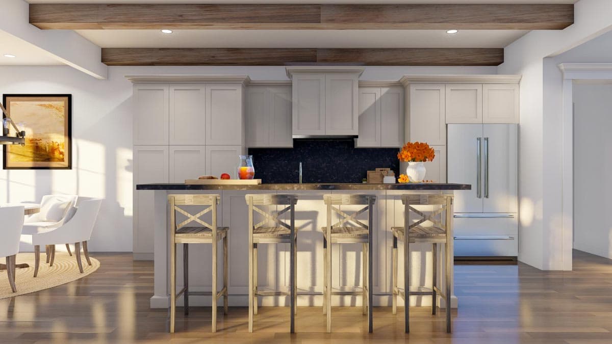 Kitchen interior with island, bar stools, stainless steel refrigerator, and wood ceiling beams.
