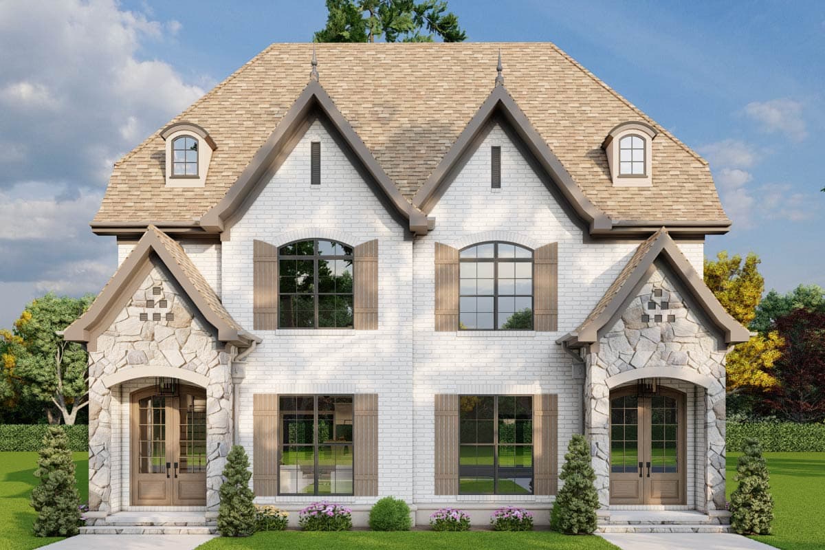 House plan exterior: Two-story white brick home with stone accents, arched windows, twin gabled dormers, and hooded entryways.