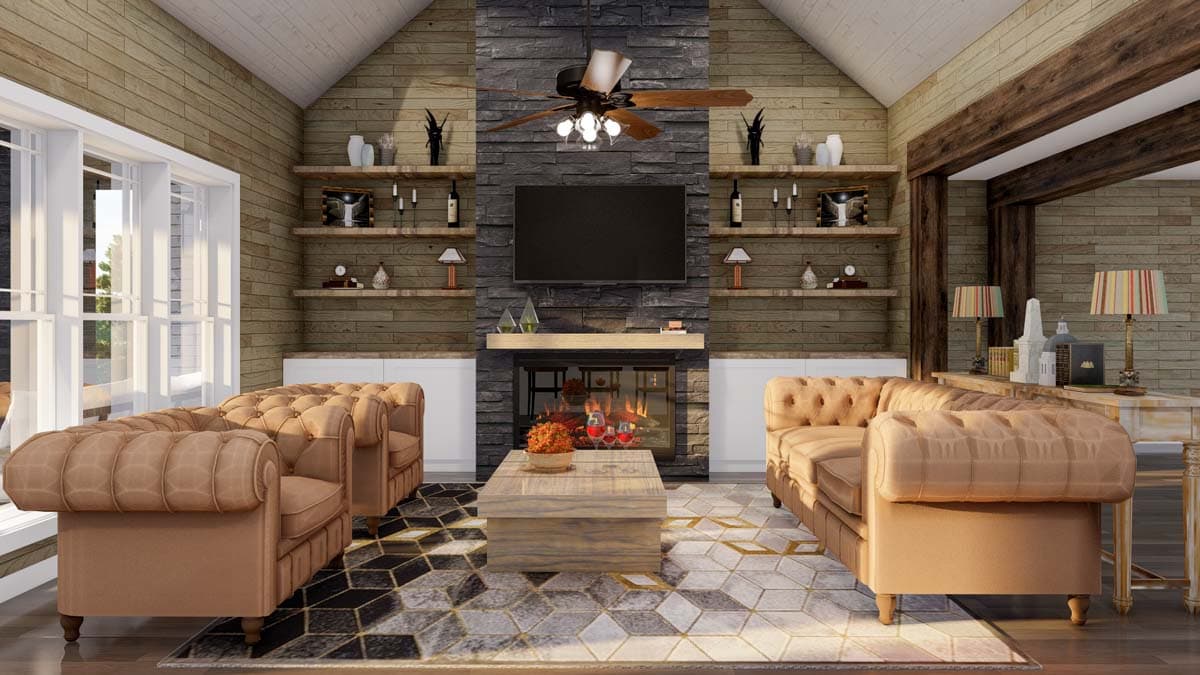 Living room with vaulted ceiling, stone fireplace, built-in shelving, and tufted sofas.