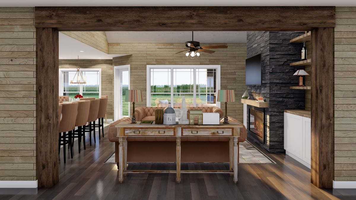 Interior rendering showing a great room with a stone fireplace, bar seating, and a large window overlooking a yard.