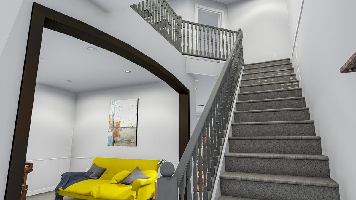 Interior view showing staircase with gray railings, dark wood beam accent, and a yellow sofa in an adjacent room.