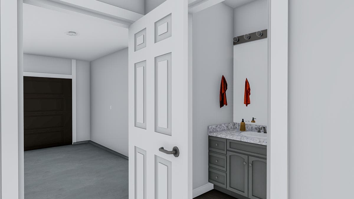 Interior view of a house plan showing a bathroom vanity with gray cabinets and a dark paneled door leading to a garage.