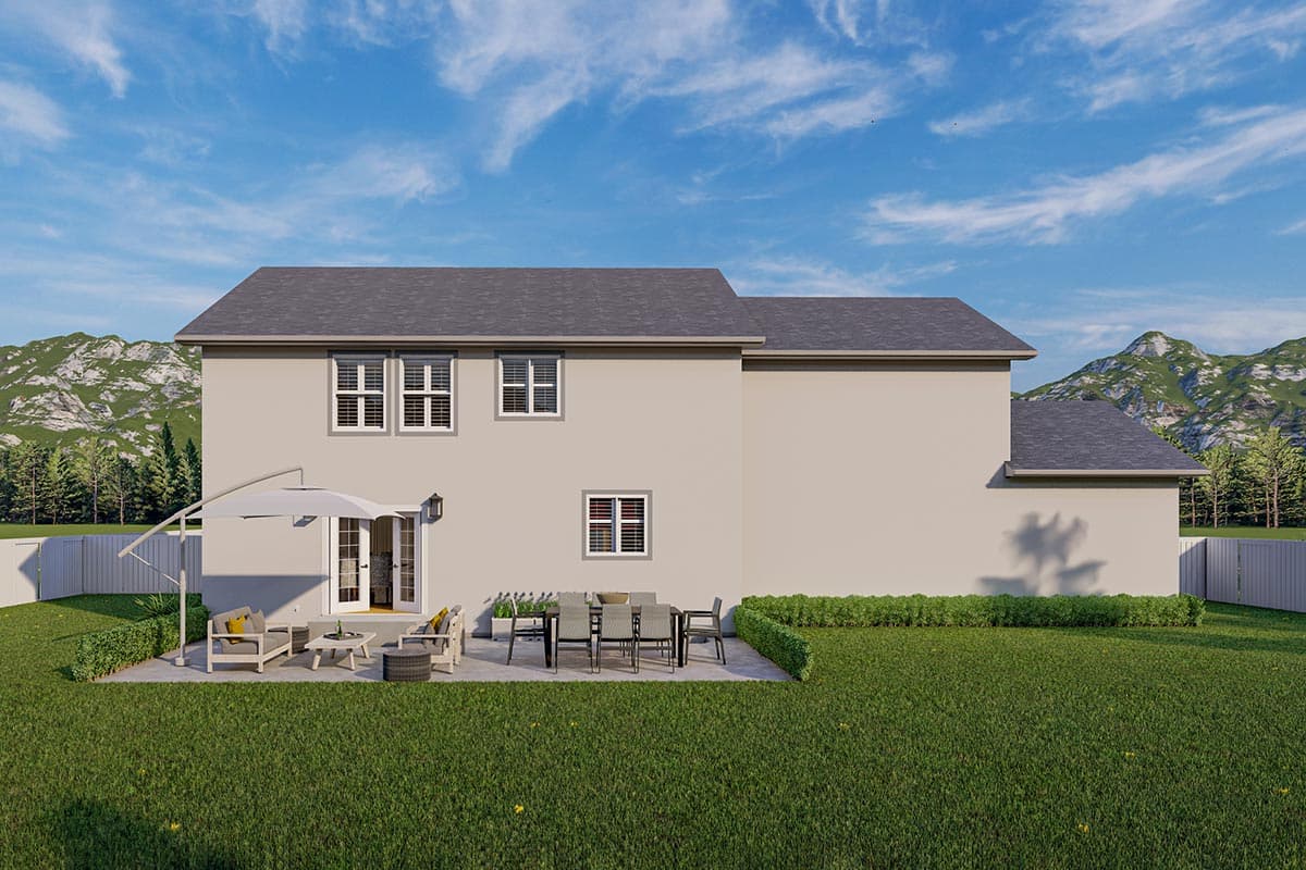 Two-story house plan exterior with a fenced backyard, patio with outdoor furniture, and a backdrop of trees and mountains.