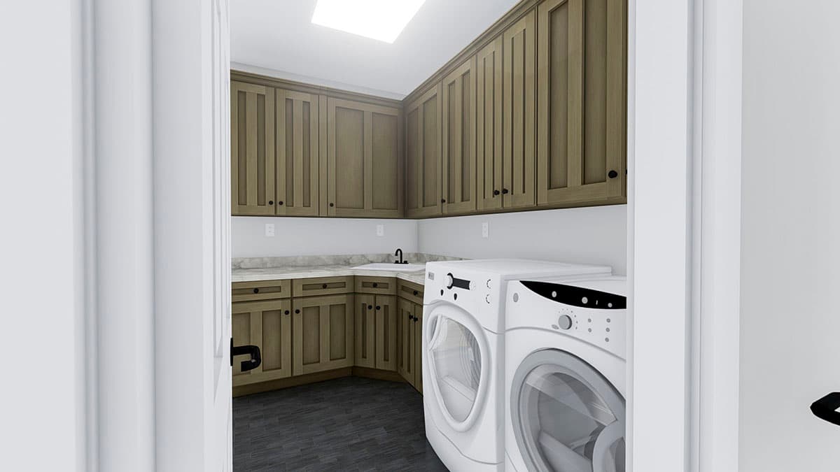 Laundry room with tan cabinets, granite countertops, sink, and front-load washer and dryer.