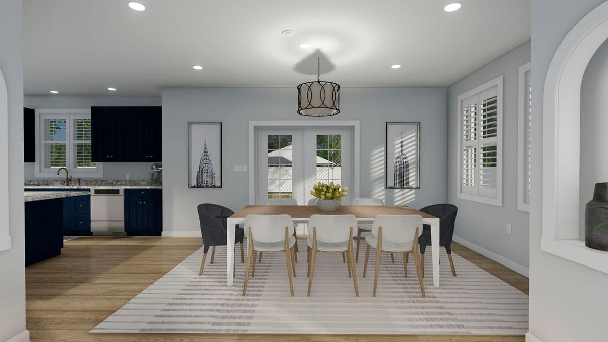 Dining area with wood table, chairs, rug, and adjacent kitchen with navy cabinets. Rendering.