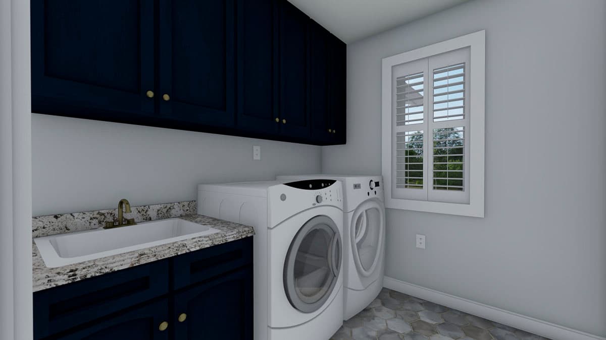 Laundry room with navy cabinets, granite countertop sink, washer and dryer, and shuttered window.