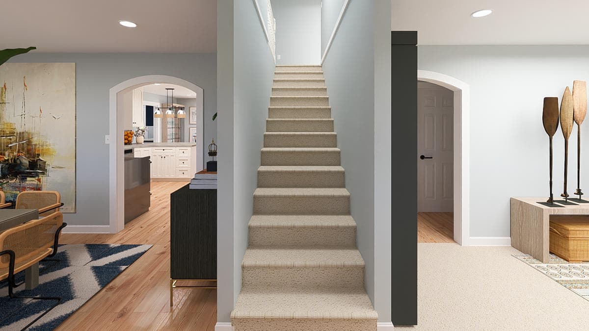 Interior view showing a carpeted staircase, arched doorway to kitchen, and dining area.